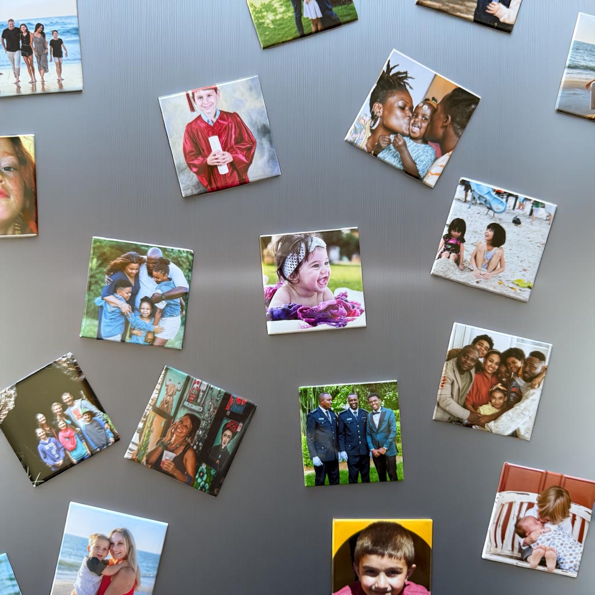 Collection of square photo magnets of various images on a gray background