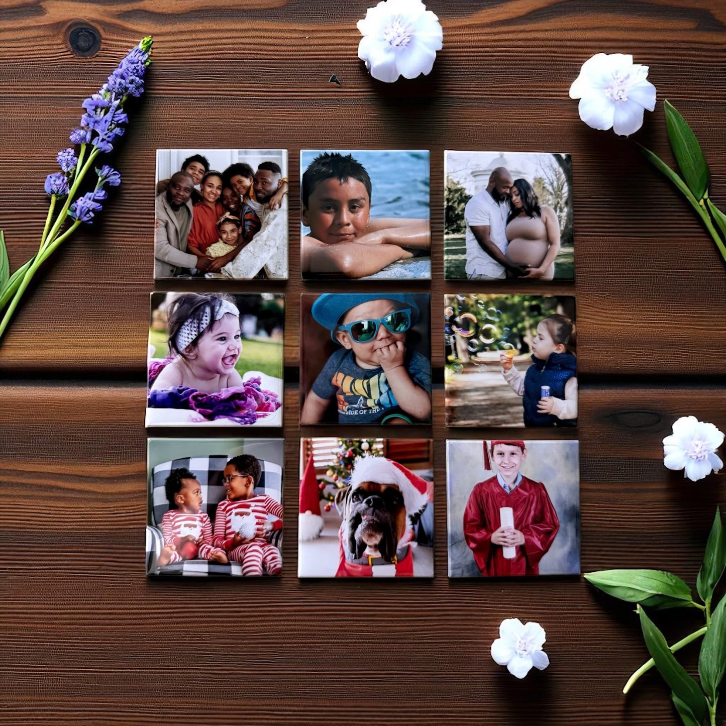 Collection of photo magnets of various images on a wooden surface with flowers