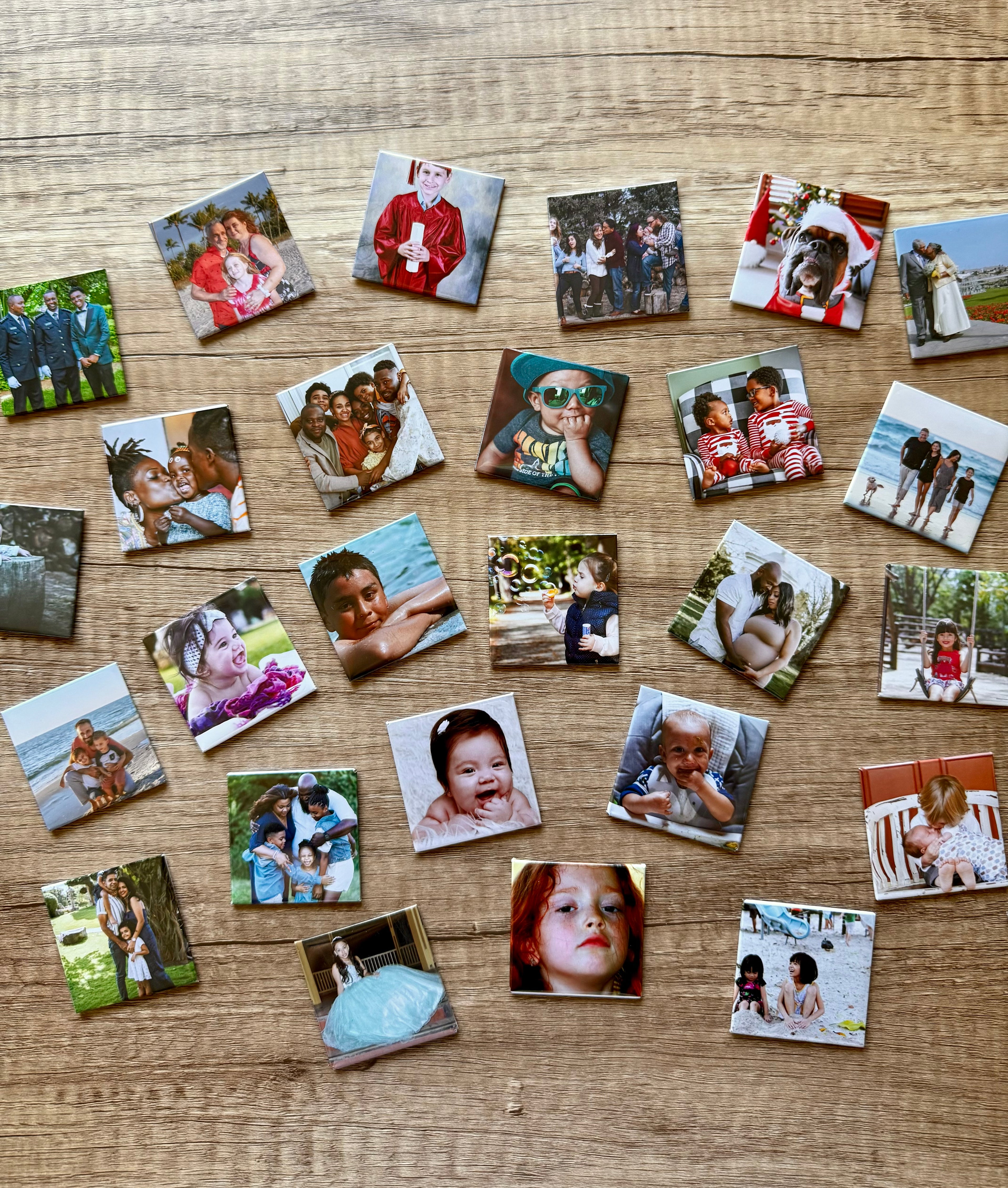 Collection of square photo magnets laying on a wooden surface